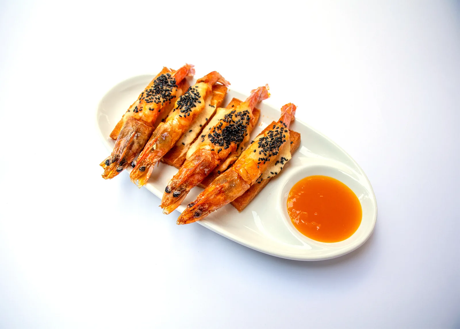 Fried black and white sesame prawns on toast