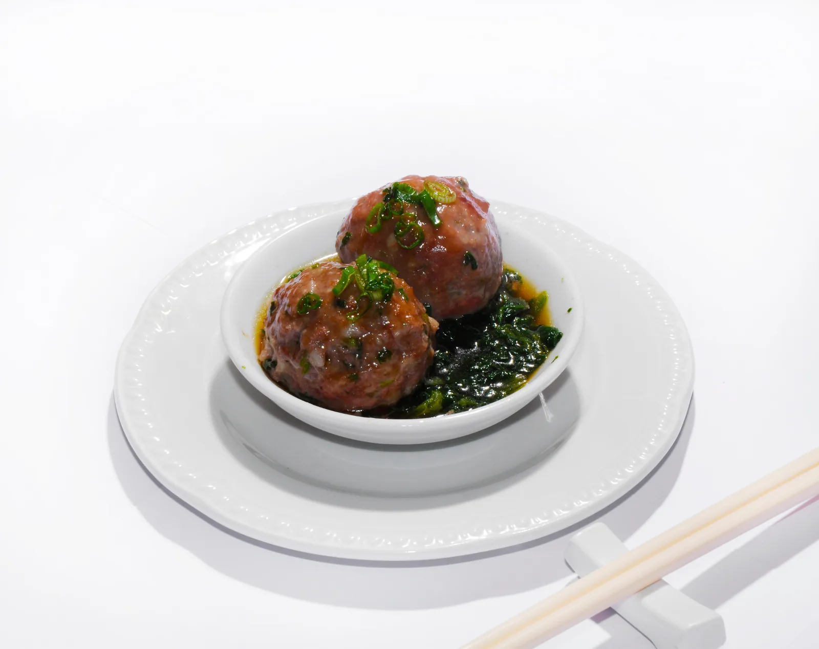 Beef meatballs on spinach leaves